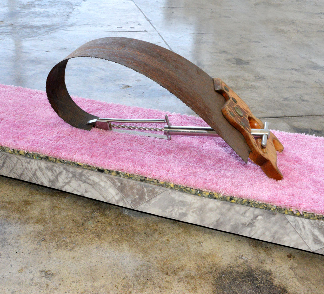 Camille Schefter, hardest working muscles, 2018, H and saw, extraction forceps, stolen carpet, padding, linoleum, wood, 14 x 104 x 9 inches (detail)